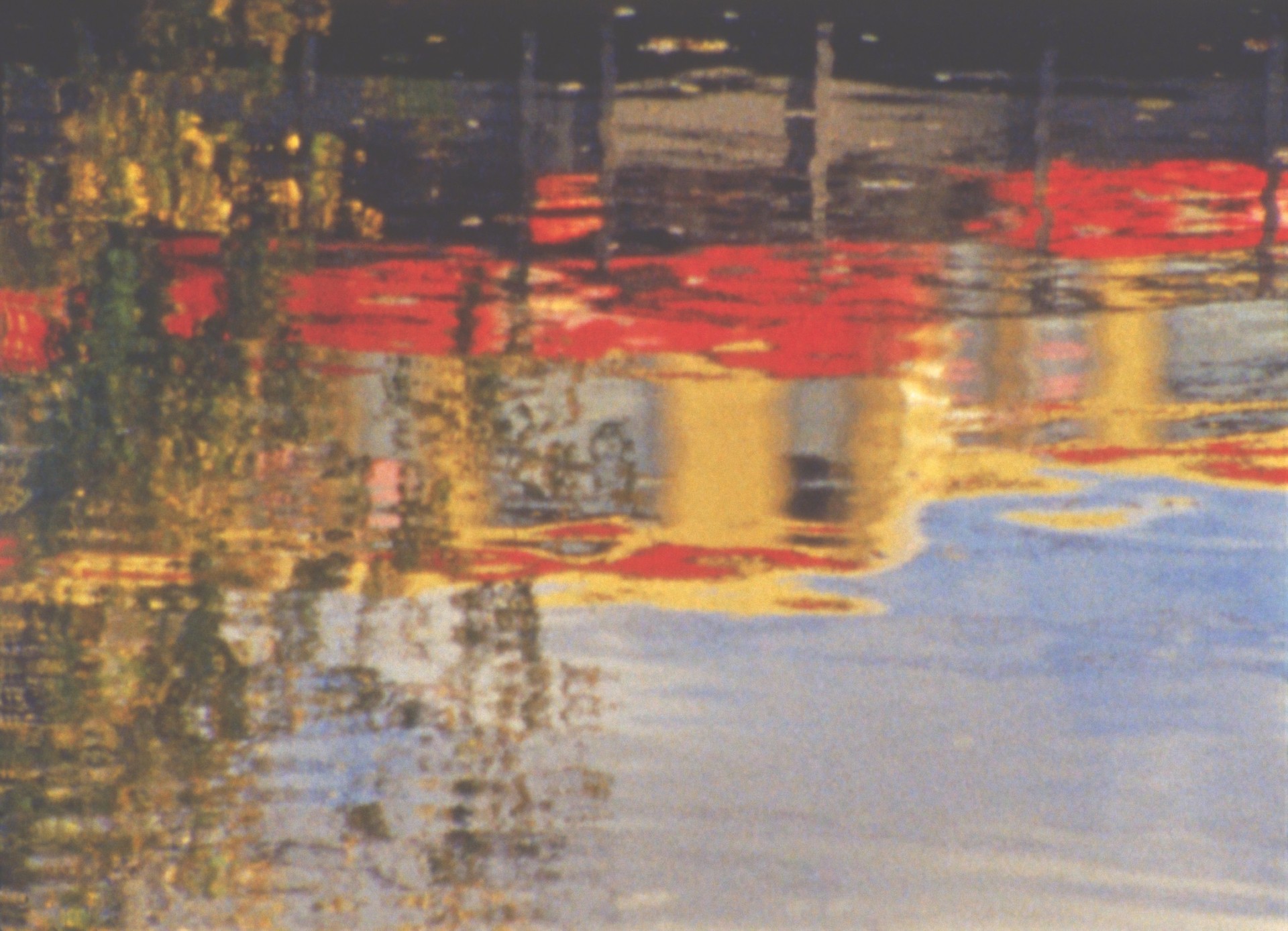 Abstrakte Wasserreflexionen in warmen Farben und weichen Lichtern schaffen eine malerische Atmosphäre.