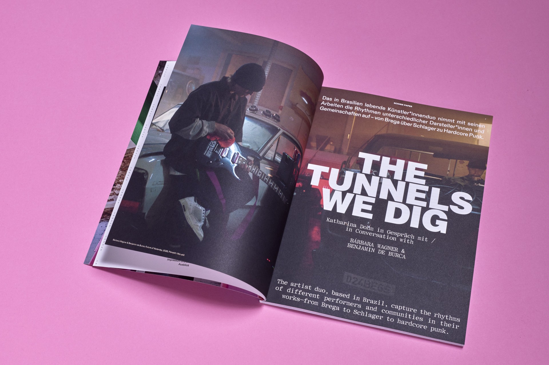 Offenes Magazin auf rosa Hintergrund mit dem Titel "DIE TUNNELS DIE WIR GRABEN" und einem Bild eines Musikers mit Gitarre.
