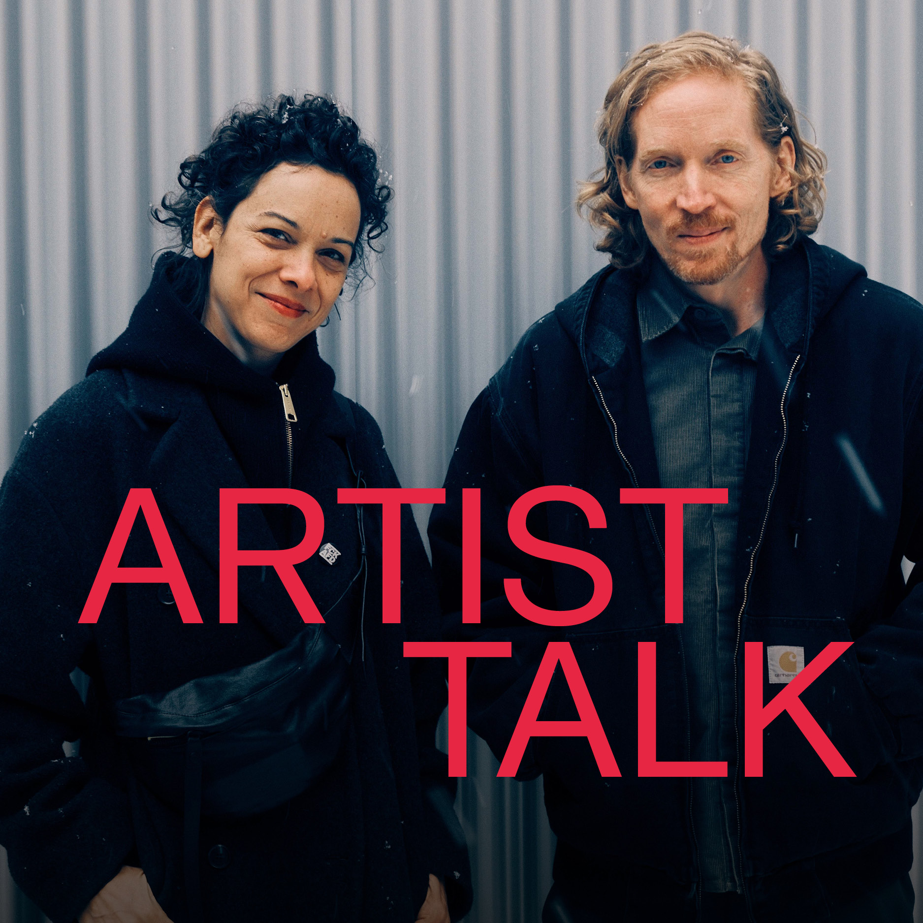 Two artistically dressed individuals stand before a wall, smiling, with the text "ARTIST TALK" in the foreground.